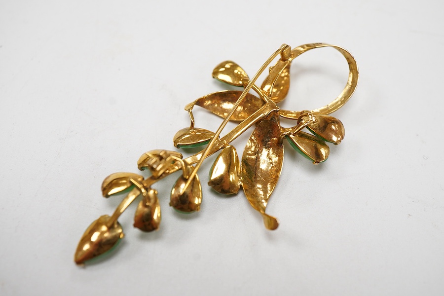 A 14k yellow metal and ten stone jade set foliate brooch, 58mm, gross weight 6 grams.
